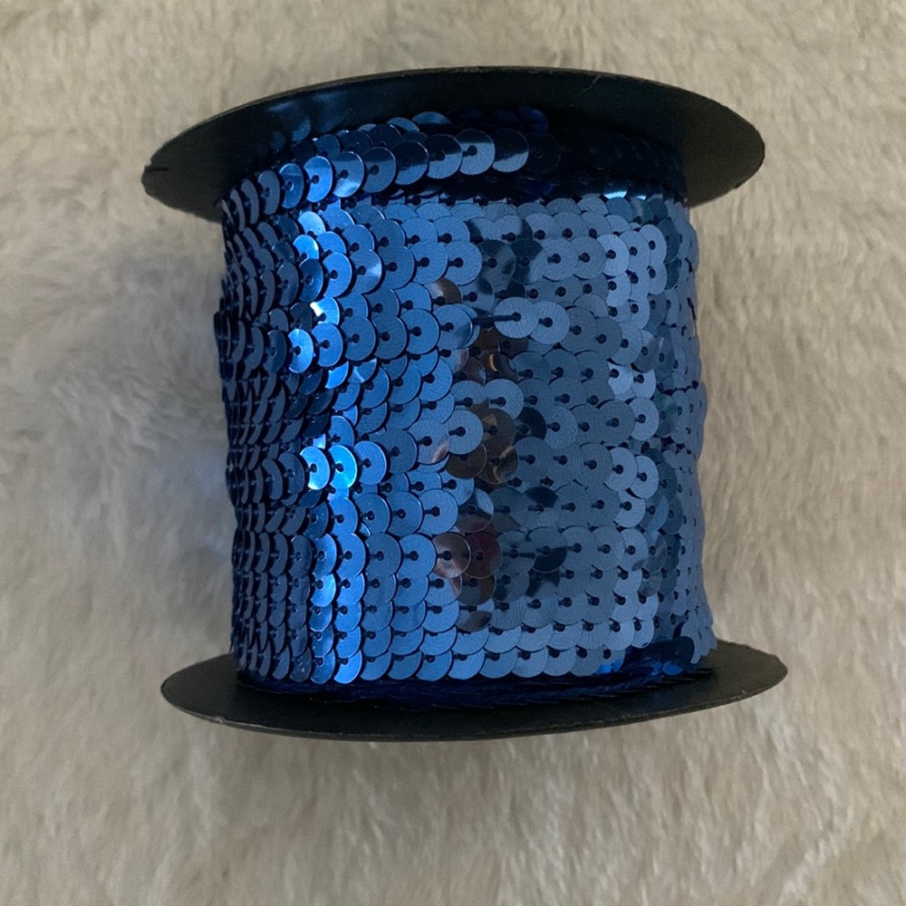 Sequins on string trim, cadet blue, 100 yard roll.